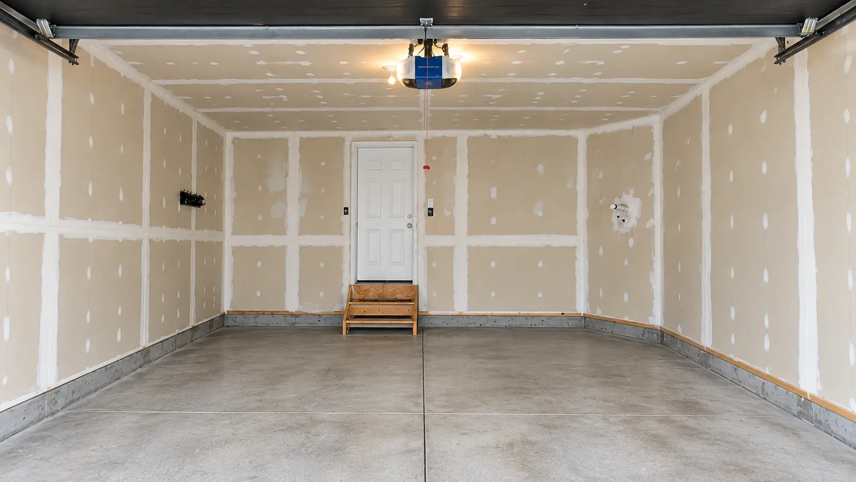 Builder-grade unfinished double garage before finishing